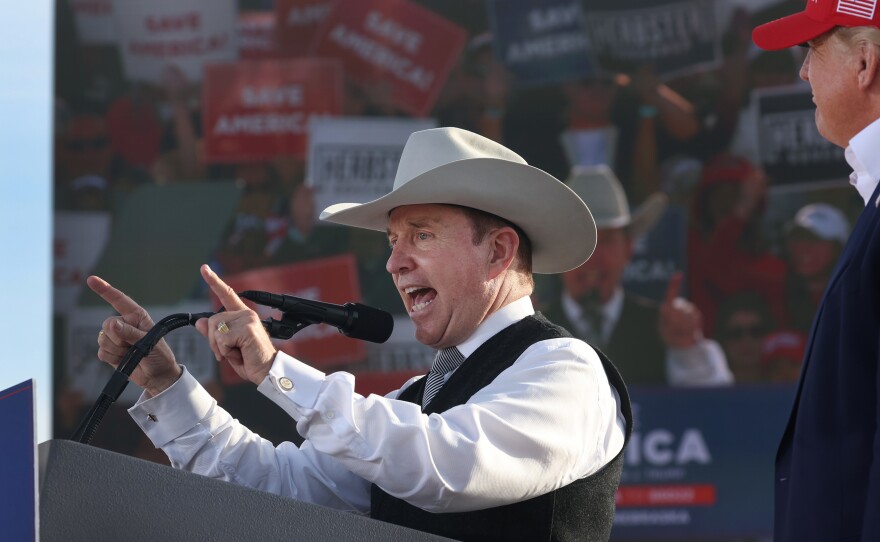 Former President Donald Trump listens as Nebraska gubernatorial candidate Charles Herbster speaks during a rally on May 1 in Greenwood, Neb.