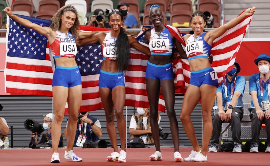 U.S. runners Sydney McLaughlin, Allyson Felix, Dalilah Muhammad and Athing Mu celebrate winning the gold medal in the women' s 4 x 400 meter relay final at the Tokyo Olympic Games.