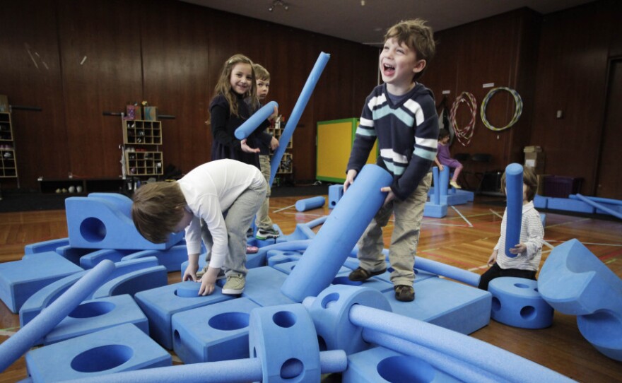 Children play with blue foam building blocks at the Blue School in New York City on March 31. The private preschool was founded by members of the Blue Man Group who wanted to send their own children to a school they felt supported creativity.