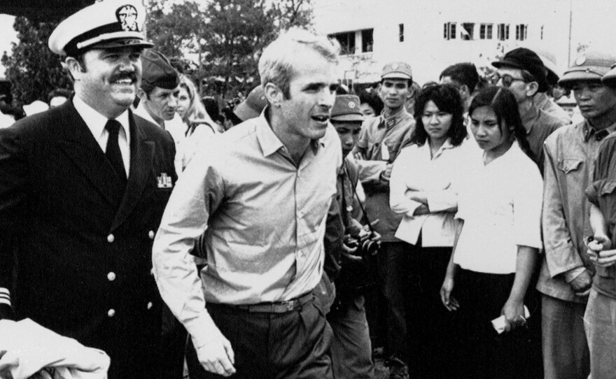 John McCain is escorted by Lt. Cmdr. Jay Coupe Jr. to Hanoi's Gia Lam Airport on March 14, 1973, after 5 1/2 years as a prisoner of war.