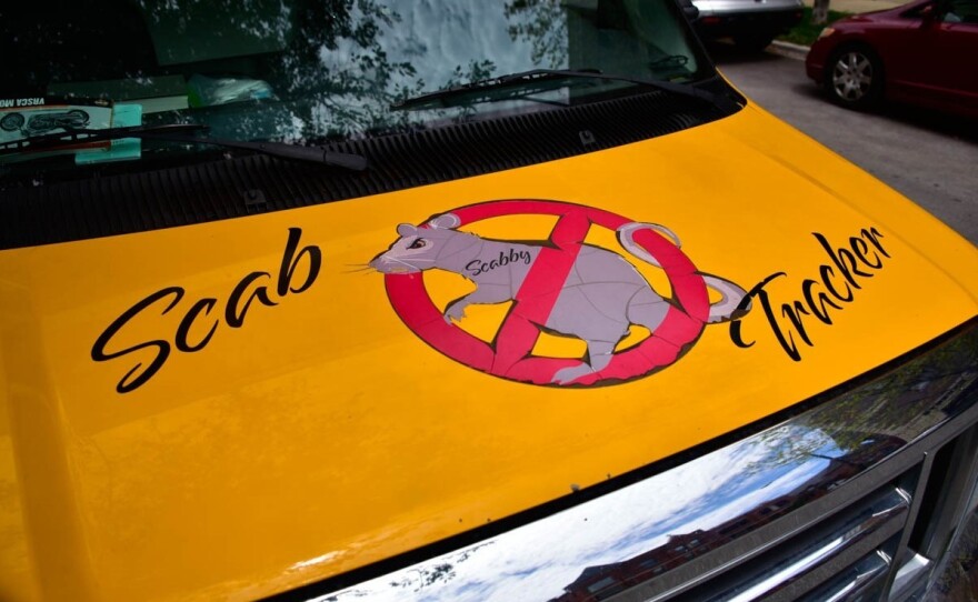 The Local 150 uses a truck decorated with the words "Scab Tracker" to transport Scabby to the front lines.