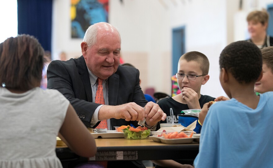 Agriculture Secretary Sonny Perdue eats lunch with students at the Catoctin Elementary School in Leesburg, Va., on Monday.