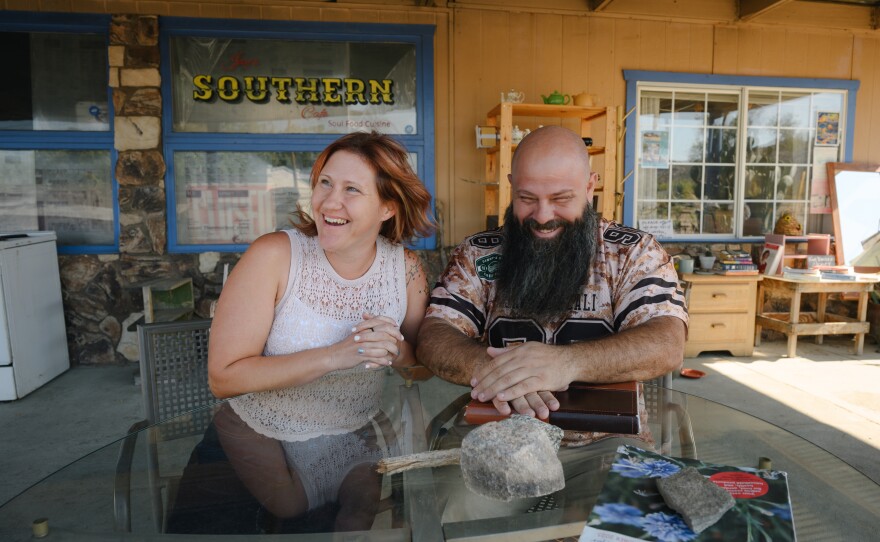 Jess Price, left, and Danny Leon share a laugh while sitting for a portrait down the street from Leon's deli in Jacumba Hot Springs, California, in East County on Sept. 26, 2025.