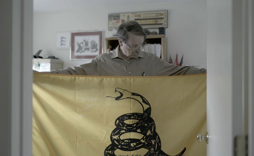 Peter Ansoff, shown holding a Gadsden Flag, is the President of the North American Vexillological Association.