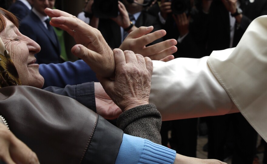 Pope Francis blesses a woman at the church of the Immaculate Conception in Baku, Azerbaijan on Sunday.