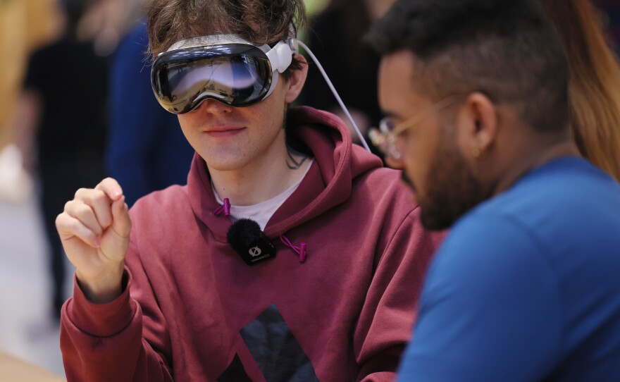A person tries out an Apple Vision Pro headset at an Apple store in New York City on Feb. 2.