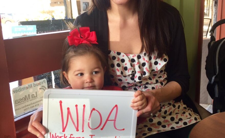Whitney Bautista of La Mesa holds up a sign showing the most important issue to her in the 2016 election, Jan. 22, 2016.