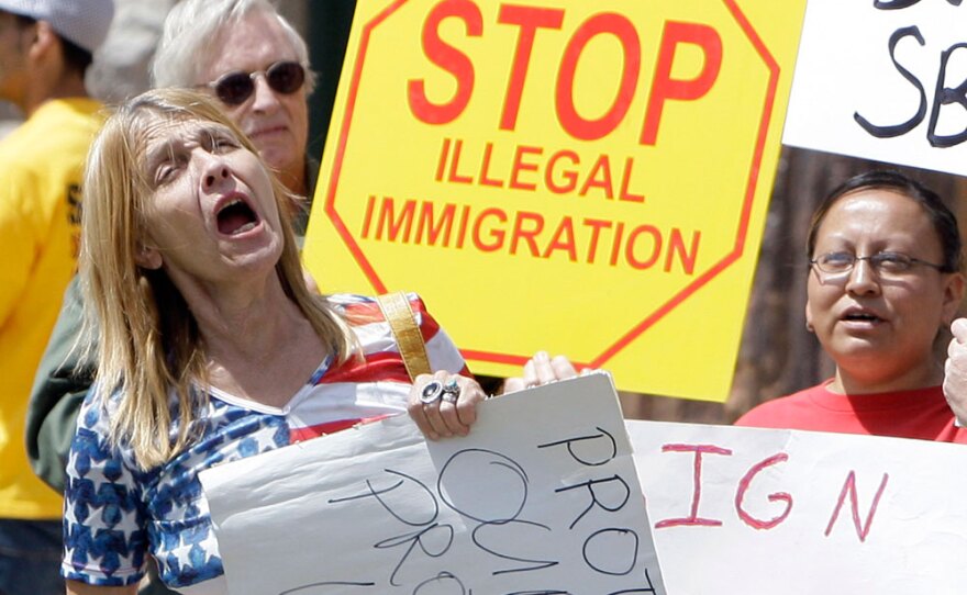 Supporters of Arizona's immigration bill rally April 23 at the state capitol in Phoenix as Gov. Jan Brewer prepared to sign the measure into law.