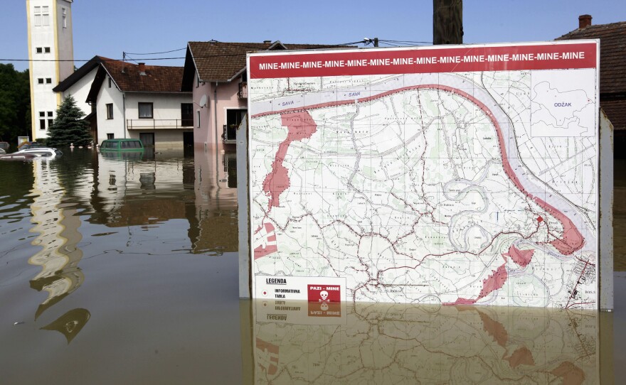 A map showing a land mine field is seen in the water during heavy floods in the village of Prud, Bosnia and Herzegovina, on Tuesday.