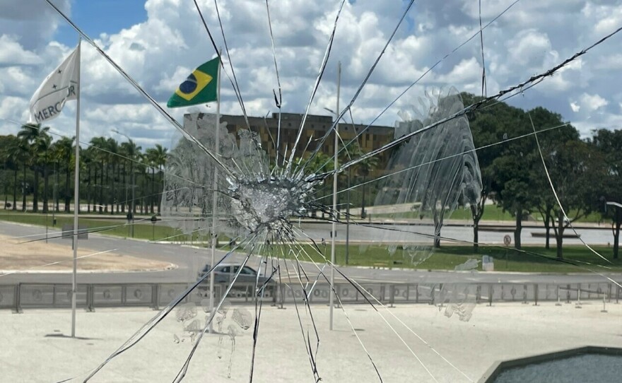 A view through a cracked window in Brazil's presidential office building looking out at Three Powers Square in Brasília, where supporters of former President Jair Bolsonaro stormed and ransacked government buildings Sunday.