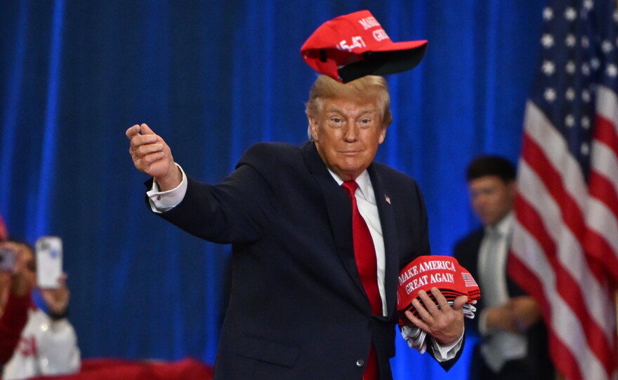 President Donald Trump throws a hat into the crowd as he arrives at a campaign rally at Lubbock Memorial Civic Center, Tuesday, Oct. 27, 2026, in Lubbock, Texas.