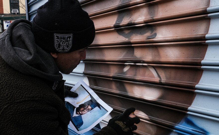 Graffiti artist Benny Guerra is painting a mural of a young Notorious BIG on St. James Pl., the block where he grew up.