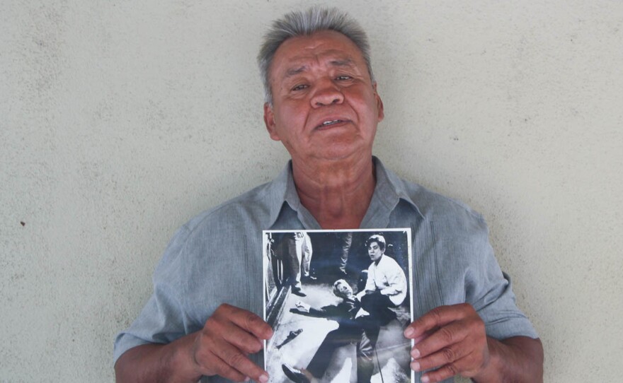 Juan Romero, 67, at his home in Modesto, Calif., holds a photo of himself and Sen. Robert F. Kennedy, taken by The Los Angeles Times' Boris Yaro on June 5, 1968.