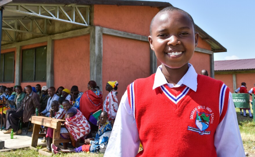 Faye, 14, a pupil at the school, proudly shows visitors the classrooms and grounds.