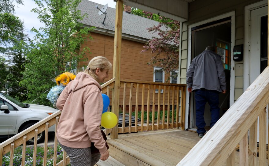 Halyna Terzi, left, and her husband Petro climb the stairs into their new apartment in Auburn, Maine, on May 16. The couple had been living in Poland after fleeing Ukraine in the early days of the war.