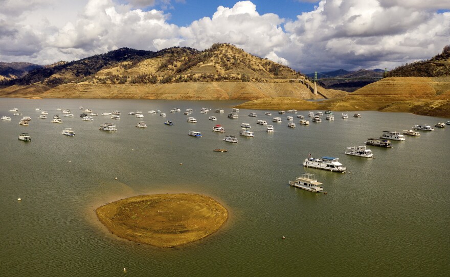 Houseboats float on Lake Oroville, Monday, Oct. 25, 2021, in Oroville, Calif. Recent storms raised the reservoir more than 16 feet, according to the California Department of Water Resources.