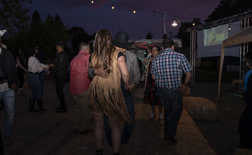 People dance at Kevin's 18th birthday party. Kevin gathered as many Michoacanos as he could invite in his community in California, many of whom were from the same small avocado-producing town his family had fled after organized crime took control.