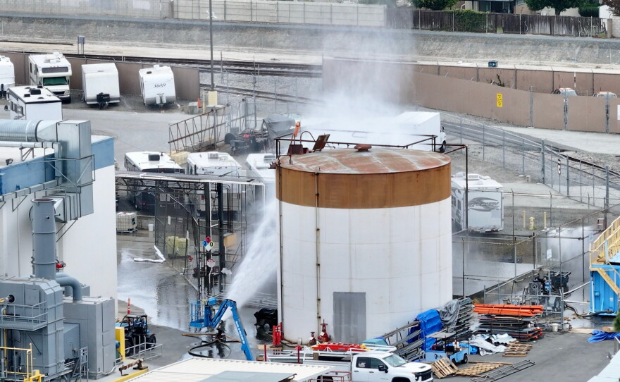 Water is sprayed on a tank that overheated at an aerospace plant in Garden Grove, Calif., on Friday.