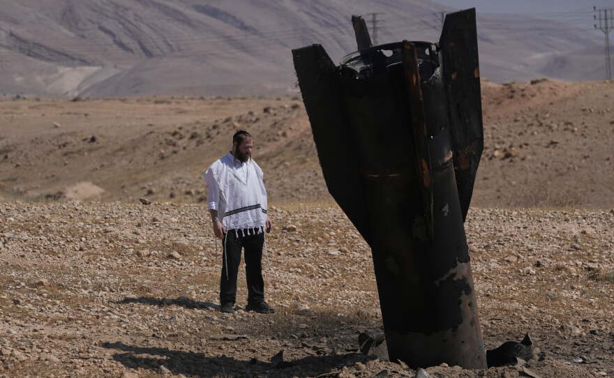 A man look at the wreckage of an Iranian missile that landed near the West Bank city of Jericho Monday, June 8, 2026.