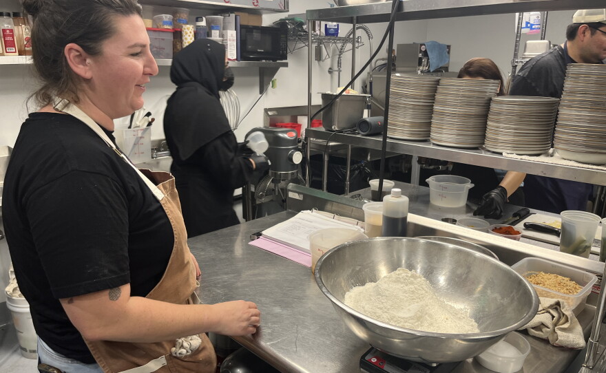Chef Ashley McBrady explains cooking techniques to participants learning in the Make Cafe kitchen, Aug. 21, 2026.