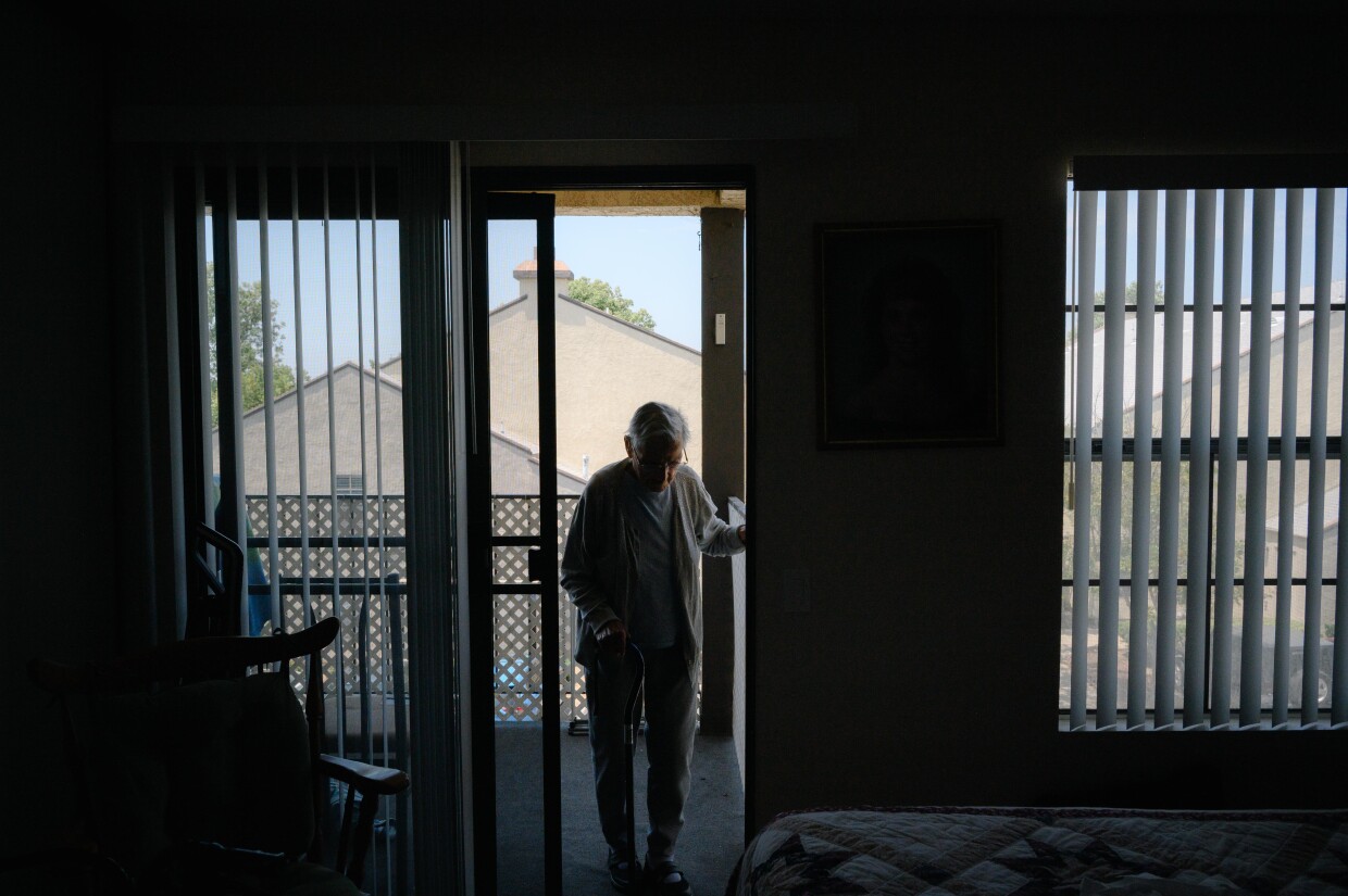 Erma Currier moves from the balcony into her bedroom at her apartment in Chula Vista on July 23, 2024. Earlier this year, the city towed Erma’s car for violating the three day-parking limit.