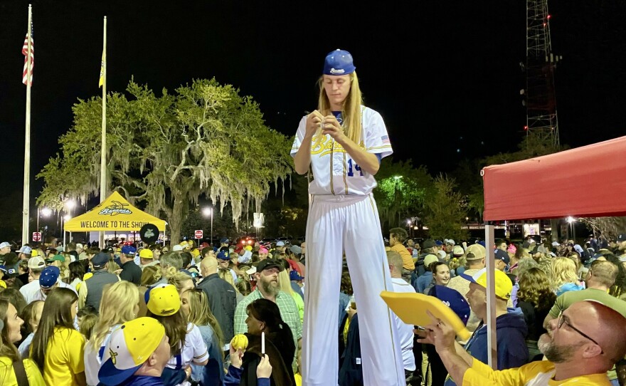 Savannah Bananas player Dakota "Stilts" Albritton signs his autograph after the game.