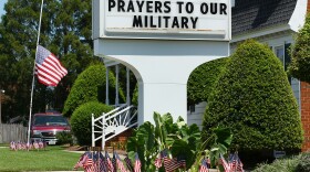 An American flag flies at half staff in front of a Realtors office to honor the fallen Navy SEALs who were based and trained close by at the Naval Amphibious Base Little Creek, on August 8, 2011 in Virginia Beach, Virginia.