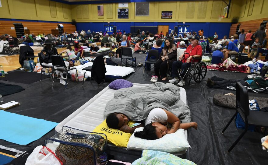 Local residents take shelter at the Pedro Menendez high school in St. Augustine, Fla., on Thursday. Some 1.5 million people are under evacuation orders in Florida in preparation for Hurricane Matthew.
