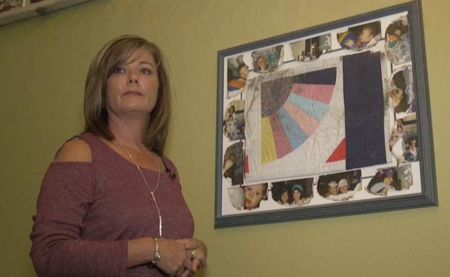 Mary Cader with the a quilt her mother made for her and a few baby pictures that survived the Oct 2007 wildfire that destroyed their home in Rancho Bernardo.  Sept 27, 2017