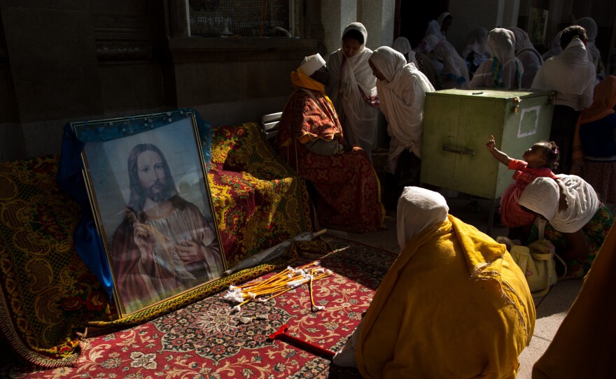 Worshippers pause before entering Bole Medhane Alem Cathedral.