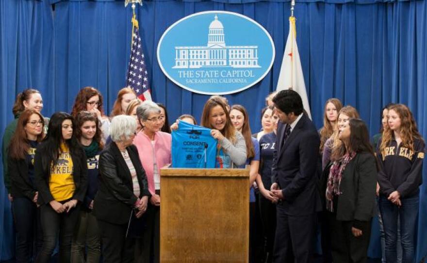 Sarah Yang, co-founder and president of the Women’s Health Initiative at UC Davis, displays a T-shirt which reads “I Mustache for Consent.”