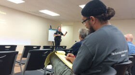 Paul Alexander takes notes during a San Diego Police Department presentation on racial profiling June 20, 2015 at the Tubman Chavez Community Center in southeastern San Diego.