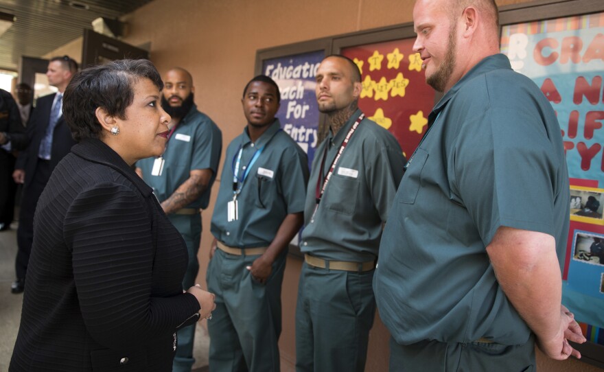 Attorney General Lynch talks with inmates, from left, Tobin Lyon, Bilal McElroy, Derrick Cash and Derek William Spinks, during a visit to Talladega Federal Correctional Institution on April 29, 2016.