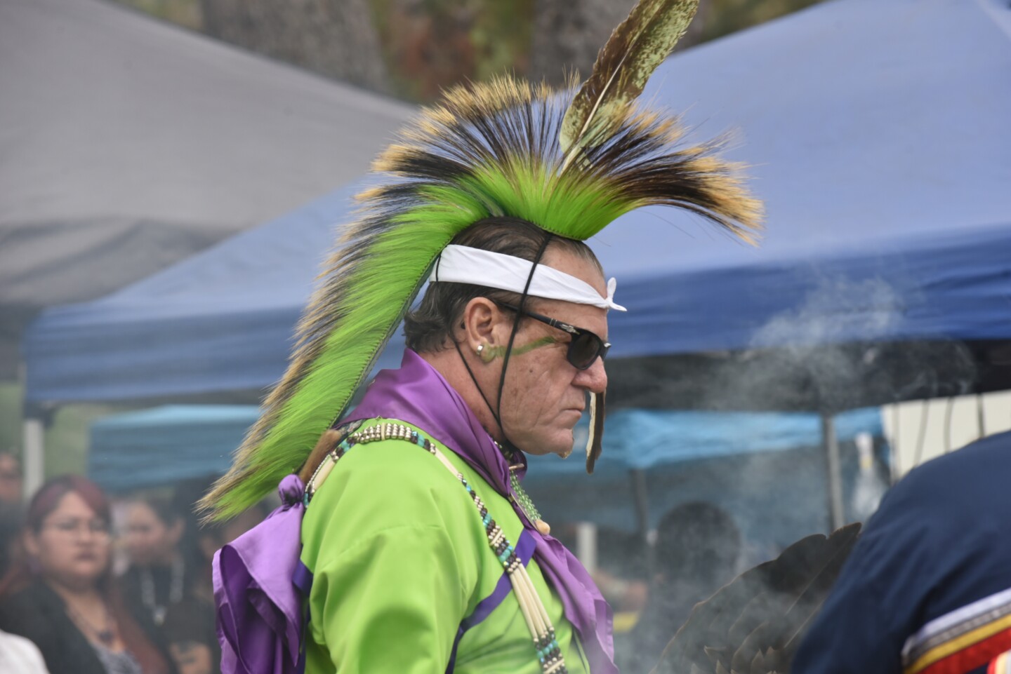 A dancer entering the arena is smudged with sacred white sage before participating in the Grand Entry at the 24th Annual San Luis Rey Intertribal Pow Wow on June 8th, 2024 in Oceanside, California.