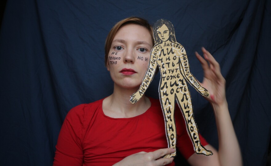 A self-portrait of Darya Apakhonchich, with the writing on her face and a figure of a woman saying: "Not only a body but a person, person, person, person, person." She made the photo in support of Russian artist and LGBTQ activist Yulia Tsvetkova, who faces criminal charges for spreading pornography through her art.