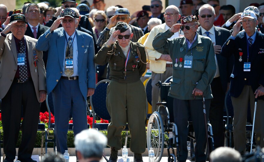 World War II veterans salute as taps is played at a ceremony Friday at the Normandy American Cemetery marking the 70th anniversary of D-Day in Colleville-sur-Mer, France.