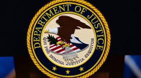 FILE - The U.S. Department of Justice logo is seen on a podium before a news conference, May 4, 2026, in Washington.