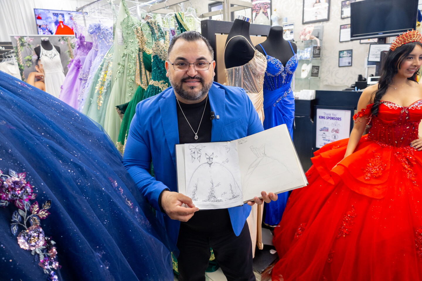 Osmar Naranjo shares one of his sketches of a custom gown he designed while model Joana Martinez models one of his completed gowns at Cynderella Brides in Chula Vista, April 30, 2026.