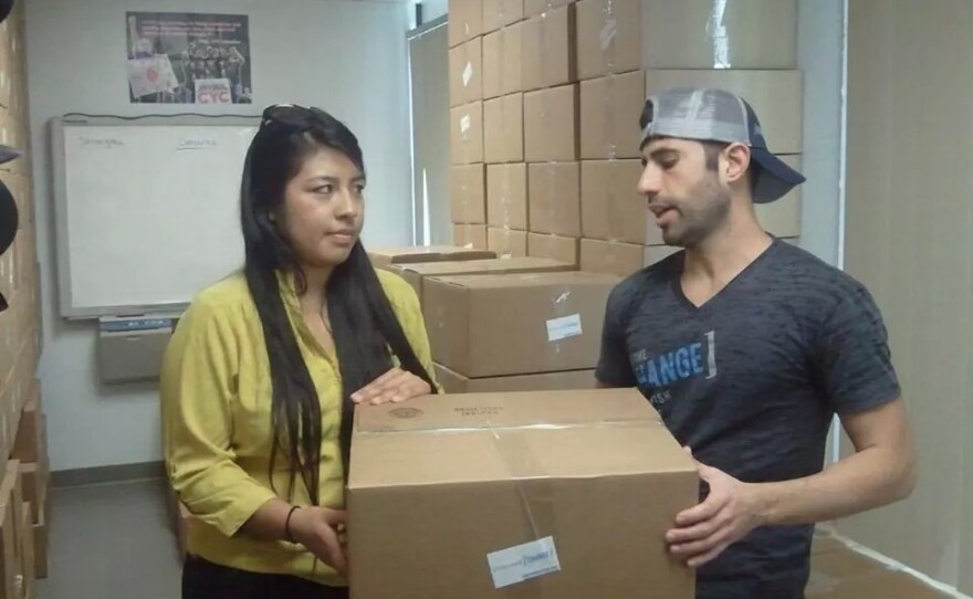 Curiel and co-founder of Power of Change, Omar Mikhail, distributing "move-in kits."