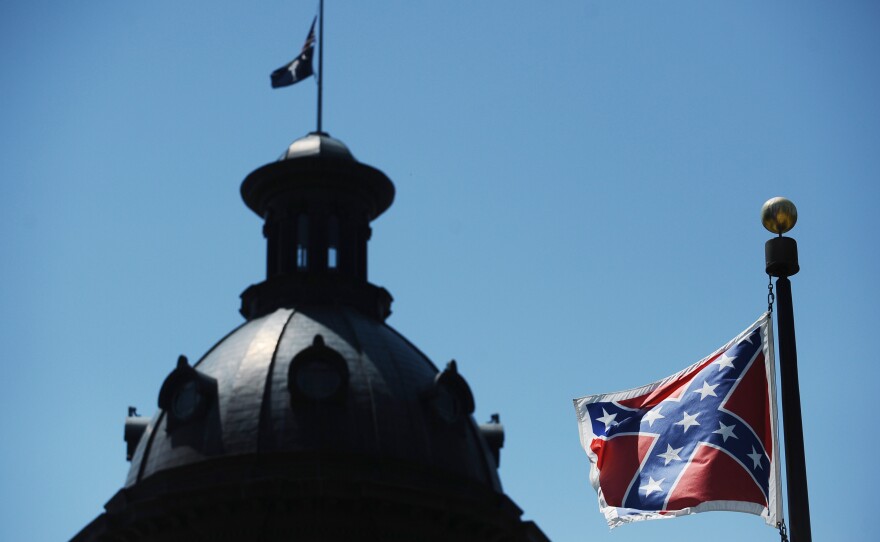 The Confederate flag flies near the South Carolina Statehouse, Friday, June 19, 2015, in Columbia, S.C. Tensions over the Confederate flag flying in the shadow of South Carolina's Capitol rose this week in the wake of the killings of nine people at a black church in Charleston, S.C.