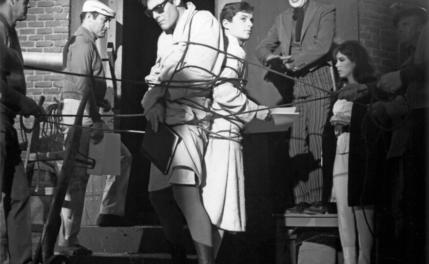 Adam West, Burt Ward, and Cesar Romero rehearse a scene in the 1960s BATMAN television series.