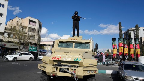 A member of police special forces stands guard on top of a vehicle in downtown Tehran, Iran, Monday.