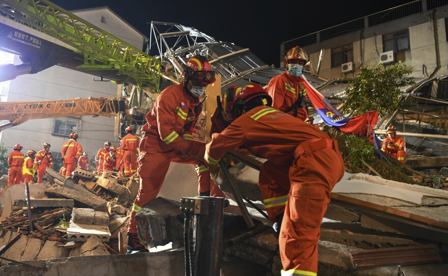 In this photo released by Xinhua News Agency, rescuers prepare equipment as they search for survivors at a collapsed hotel in Suzhou in eastern China's Jiangsu Province on Monday, July 12. The hotel building collapsed Monday afternoon.