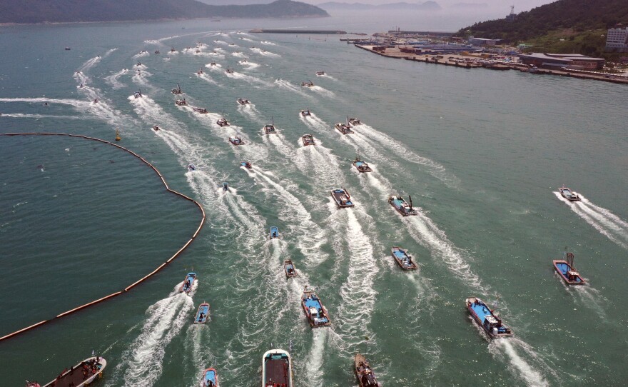 South Korean fishing boats stage a maritime parade to protest against the planned release of treated radioactive water from Japan's wrecked Fukushima nuclear power plant into the sea, on the seas off Wando, South Korea, last Friday.