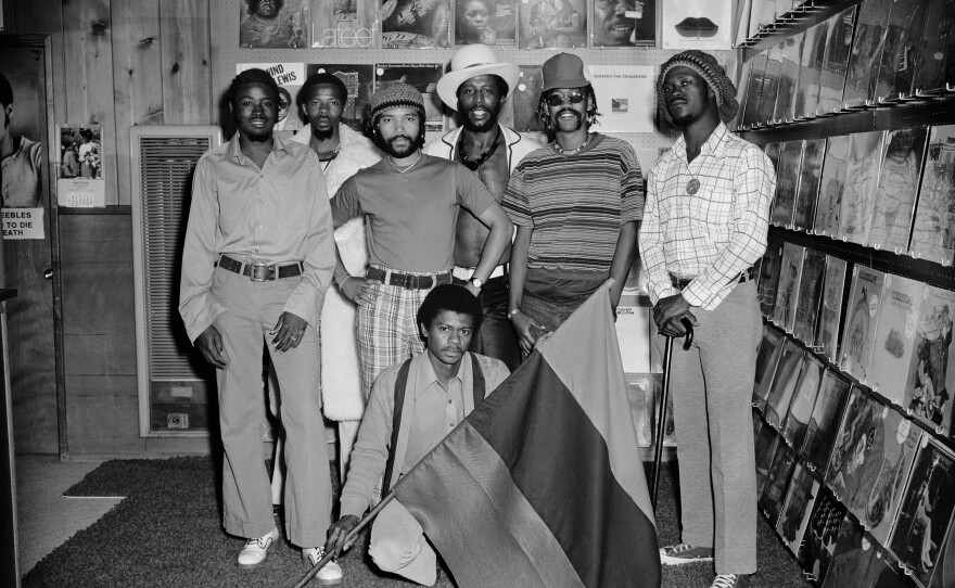 Men inside the RBG House of Music located at 4268 Market street. Earl Mitchell, father of baseball player Kevin Mitchell, stands in the center with a white hat, April 1974.
