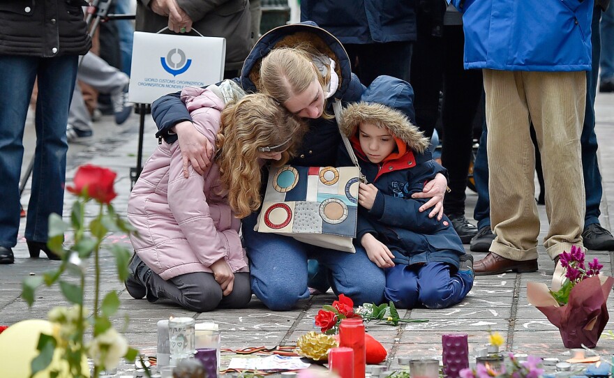People mourn for the victims of the bombings at the Place de la Bourse, in the center of Brussels, on Wednesday.