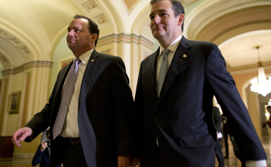 Sen. Mike Lee, R-Utah (left), and Sen. Ted Cruz, R-Texas, walk to the Senate floor on Oct. 16 to vote on a bill to raise the debt ceiling and fund the government.