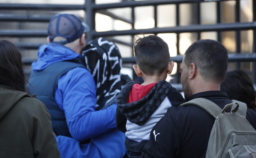 Honduran asylum seekers enter the U.S. at San Diego's Otay Mesa port of entry, as seen from Tijuana, Mexico.