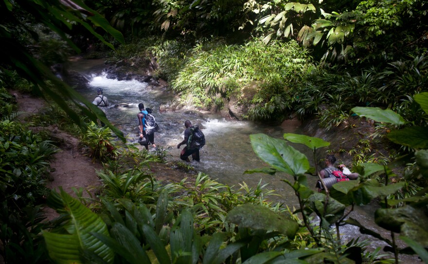 Haitian migrants cross the Acandí Seco river in Colombia along their route through the Darién jungle in September.
