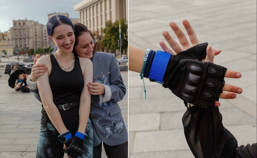 Left: Phantom Blue dancers hug and laugh after they finish a recording take. Right: Phantom Blue dancers clap their hands together during recording.